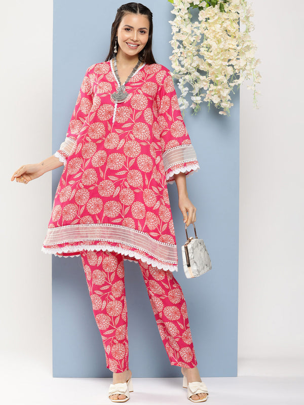 Jashvi Pink Floral Print A- Line Kurta With Lace Detailing & Pink Floral Print Trousers.