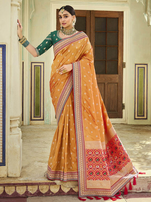 Artistic Yellow Banarasi Silk Saree With Heavy Thread Work Paired With Green Blouse